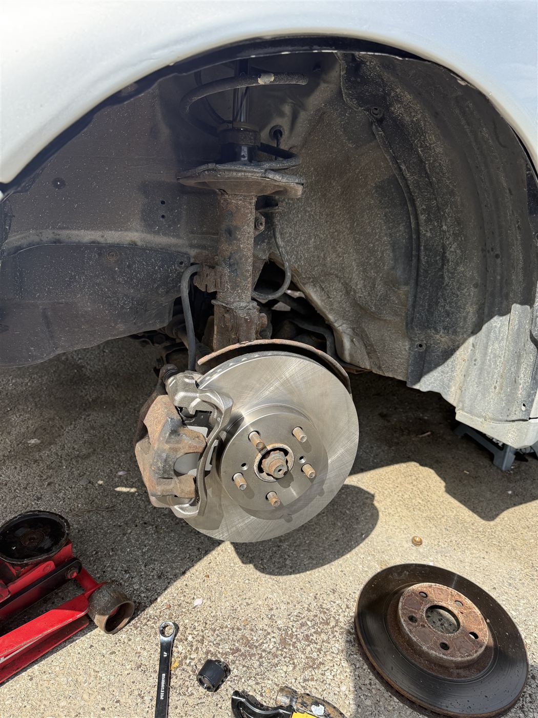 New front brake rotor and caliper reinstalled on the hub